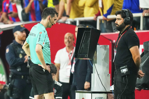 FILE - Referee Ricardo De Burgos Bengoetxea watches the VAR during the Spanish Copa del Rey final soccer match between Barcelona and Real Madrid at Estadio de La Cartuja stadium in Seville, Spain, Saturday, April 26, 2025. (AP Photo/Jose Breton, file)