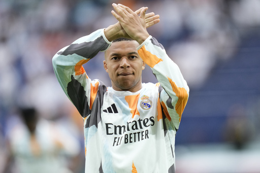 Real Madrid's Kylian Mbappe warms-up prior to a Spanish La Liga soccer match against Real Sociedad at Santiago Bernabeu stadium in Madrid, Saturday, May 24, 2025. (AP Photo/Cesar Cebolla)