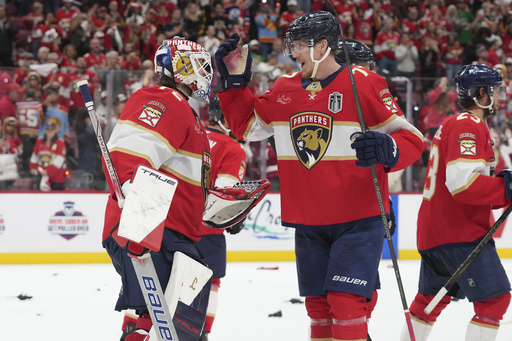Florida Panthers defenseman Niko Mikkola (77) congratulates goaltender Sergei Bobrovsky (72) after defeating the Edmonton Oilers in Game 3 of the NHL Stanley Cup final Monday, June 9, 2025, in Sunrise, Fla. (AP Photo/Lynne Sladky)