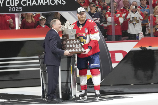 NHL commissioner Gary Bettman presents the Conn Smythe Trophy to Sam Bennett after defeating the Edmonton Oilers in Game 6 of the NHL hockey Stanley Cup Final Tuesday, June 17, 2025, in Sunrise, Fla. (AP Photo/Lynne Sladky)