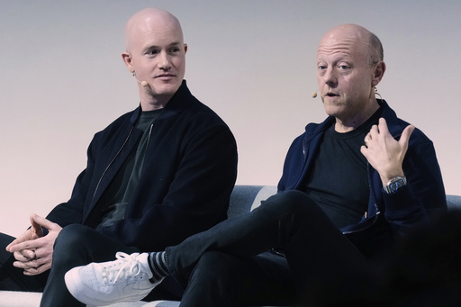 Brian Armstrong, left, Co-founder and CEO of Coinbase, and Jeremy Allaire, Co-Founder, Chairman and CEO of Circle, participate in the State of Crypto Summit, in New York, Thursday, June 12, 2025. (AP Photo/Richard Drew)