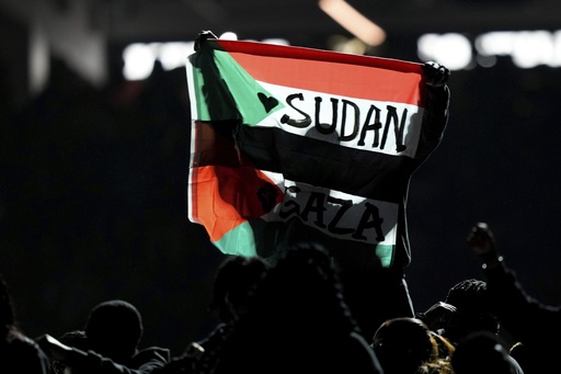 FILE - A person holds up a flag during halftime of the NFL Super Bowl 59 football game between the Kansas City Chiefs and the Philadelphia Eagles, Feb. 9, 2025, in New Orleans. (AP Photo/Matt Slocum, File)