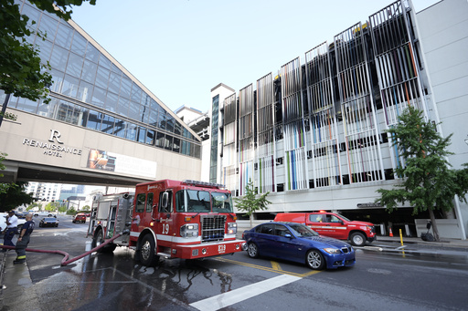 A fire truck is seen outside a parking garage where vehicles caught fire and part of a floor in the structure collapsed Tuesday, June 10, 2025, in Nashville, Tenn. (AP Photo/George Walker IV)