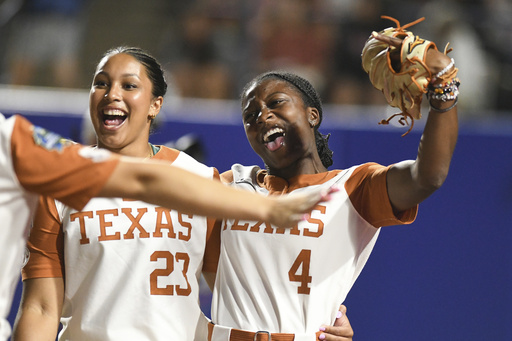 Texas infielder Viviana Martinez (23) and outfielder Adayah Wallace (4) celebrate after beating Texas Tech during the first game of the NCAA softball Women's College World Series finals in Oklahoma City, Wednesday, June 4, 2025. (AP Photo/Kyle Phillips)