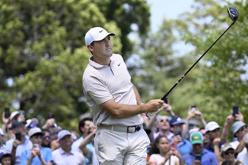 Scottie Scheffler watches his shot from the first tee during the first round of the Travelers Championship golf tournament at TPC River Highlands, Thursday, June 19, 2025, in Cromwell, Conn. (AP Photo/Jessica Hill)