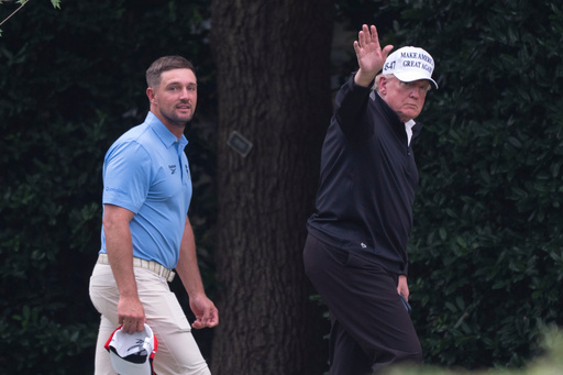 President Donald Trump, right, walks toward the Oval Office as he returns to the White House with Bryson DeChambeau, winner of the 2024 U.S. Open, after playing golf, Sunday, June 1, 2025. (AP Photo/Manuel Balce Ceneta)