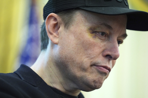 Elon Musk listens as President Donald Trump speaks during a news conference in the Oval Office of the White House, Friday, May 30, 2025, in Washington. (AP Photo/Evan Vucci)