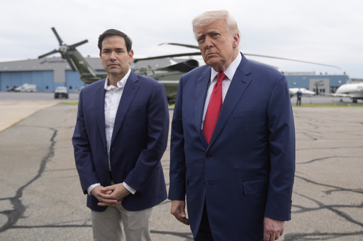 President Donald Trump, right, listens to a question from a reporter alongside Secretary of State Marco Rubio upon arriving at Morristown Municipal Airport in Morristown, N.J., en route to Camp David, Md., Sunday, June 8, 2025. (AP Photo/Manuel Balce Ceneta)