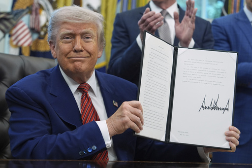 FILE - President Donald Trump holds an executive order regarding the reform of the Nuclear Regulatory Commission in the Oval Office of the White House, May 23, 2025, in Washington. (AP Photo/Evan Vucci, File)