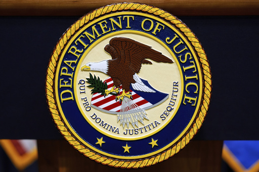 FILE - The U.S. Department of Justice logo is seen on a podium before a press conference with Attorney General Pam Bondi, Tuesday, May 6, 2025, at the Justice Department in Washington. (AP Photo/Julia Demaree Nikhinson, file)