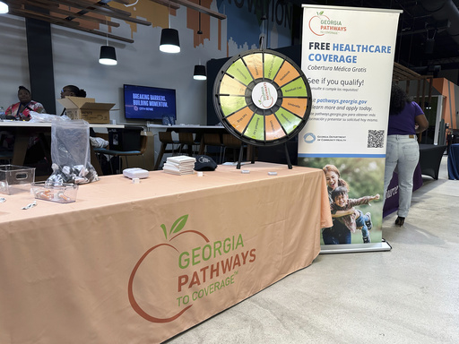 A stand for Georgia Pathways is seen at a job fair in Atlanta, Ga. Thursday, June 5, 2025. (AP Photo/Sudhin Thanawala)