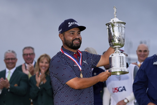 J.J. Spaun celebrates with the trophy after winning the U.S. Open golf tournament at Oakmont Country Club Sunday, June 15, 2025, in Oakmont, Pa. (AP Photo/Carolyn Kaster)