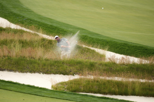Scottie Scheffler plays out of the Church Pews bunker on the third hole during the second round of the U.S. Open golf tournament at Oakmont Country Club Friday, June 13, 2025, in Oakmont, Pa. (AP Photo/Charlie Riedel)