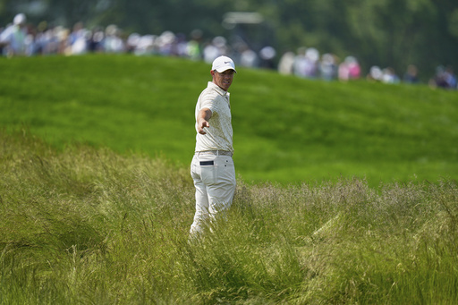 Rory McIlroy, of Northern Ireland, prepares to hit from the tall grass on the fourth hole during the first round of the U.S. Open golf tournament at Oakmont Country Club Thursday, June 12, 2025, in Oakmont, Pa. (AP Photo/Seth Wenig)