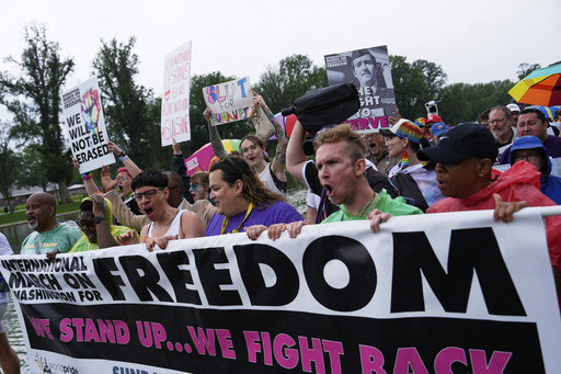 People attend the World Pride Rally and March at the Lincoln Memorial, Sunday, June 8, 2025, on the National Mall in Washington. (AP Photo/Julia Demaree Nikhinson)