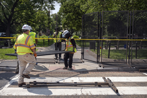 Workers put up fencing around Dupont Circle ahead of the World Pride Parade, Friday, June 6, 2025, in Washington. (AP Photo/Mark Schiefelbein)