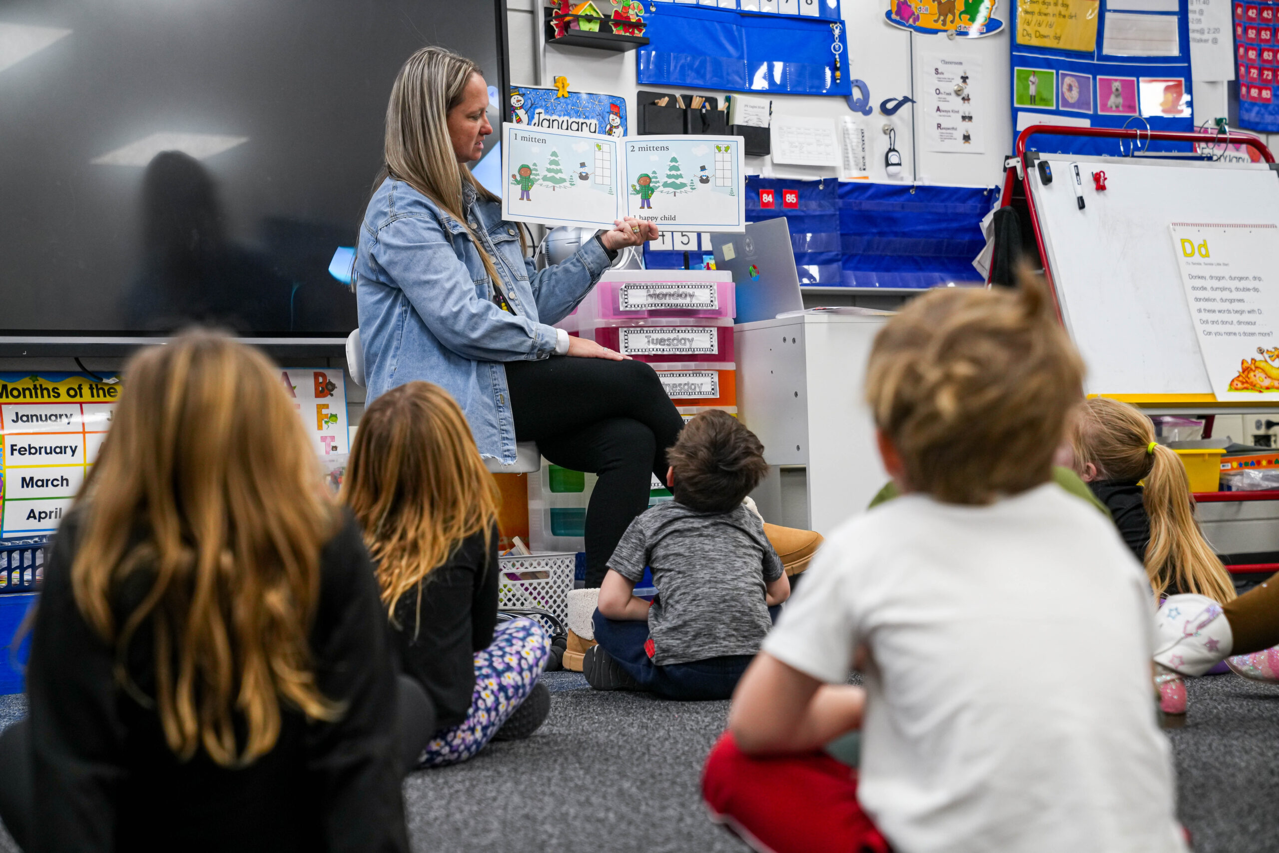 A Sioux Falls School District educator reads a book to junior kindergarten students in a classroom. (Courtesy of Sioux Falls School District)