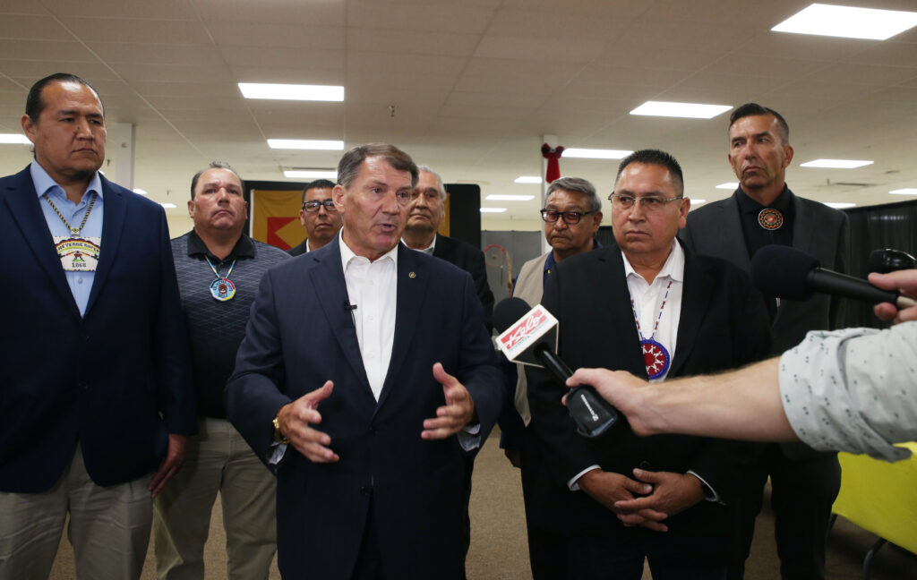U.S. Sen. Mike Rounds (center) and tribal leaders speak to the media after a public safety roundtable on Aug. 14, 2024, in Wagner. With Rounds, from left, are Cheyenne River Chairman Ryman LeBeau, Lower Brule Chairman Clyde Estes, Sisseton Wahpeton Secretary Curtis Bissonette, Wayne Boyd of Rosebud Sioux Tribe, Yankton Chairman Robert Flying Hawk, Oglala President Frank Star Comes out and Crow Creek Chairman Peter Lengkeek. (Makenzie Huber/South Dakota Searchlight)