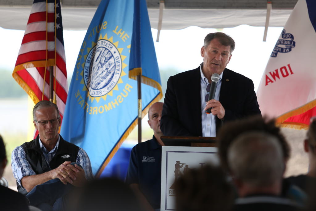 U.S. Sen. Mike Rounds, R-South Dakota, speaks at Madison's Lewis and Clark Regional Water System ribbon cutting on Aug. 21, 2024. At left is U.S. Sen. John Thune, R-South Dakota. (Makenzie Huber, South Dakota Searchlight)