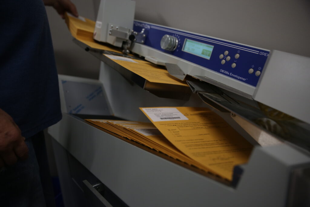 Election workers count absentee ballots for Minnehaha County on Nov. 5, 2024, in the county administration building. (Makenzie Huber/South Dakota Searchlight)