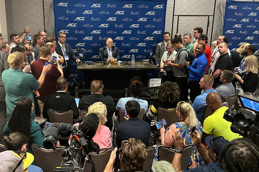North Carolina coach Bill Belichick speaks with a group of reporters during the Atlantic Coast Conference's NCAA college football media days, Thursday, July 24, 2025, in Charlotte, N.C. (AP Photo/Aaron Beard)