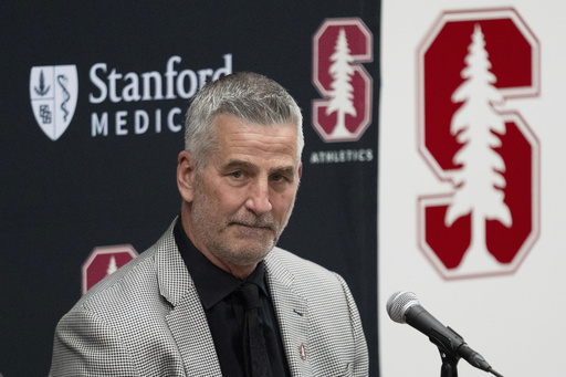 FILE - Stanford's new coach Frank Reich listens as he's introduced during NCAA college football news conference, Tuesday, April 1, 2025, in Stanford, Calif. (AP Photo/Emily Steinberger, File)