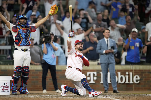 Philadelphia Phillies Kyle Schwarber celebrates after winning the tiebreaker at the MLB baseball All-Star game between the American League and National League, Tuesday, July 15, 2025, in Atlanta. (AP Photo/Brynn Anderson)