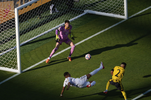 Real Madrid's Kylian Mbappe, bottom, scores his side's 3rd goal during the Club World Cup quarterfinal soccer match between Real Madrid and Borussia Dortmund in East Rutherford, N.J., Saturday, July 5, 2025. (AP Photo/Pamela Smith)