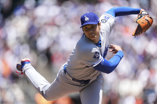 Los Angeles Dodgers' Shohei Ohtani follows through on his pitch to a San Francisco Giants batter during the third inning of a baseball game Saturday, July 12, 2025, in San Francisco. (AP Photo/Godofredo A. Vásquez)