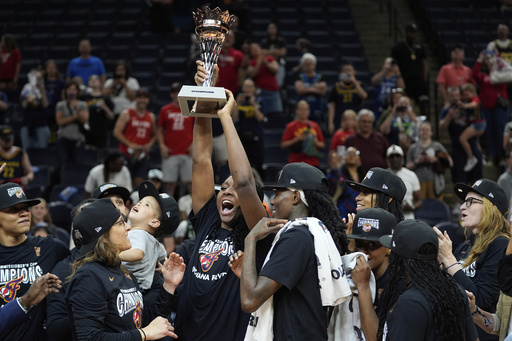 Indiana Fever forward Aliyah Boston (7), holding trophy, celebrates after winning the WNBA Commissioner's Cup championship basketball game against the Minnesota Lynx, Tuesday, July 1, 2025, in Minneapolis. (AP Photo/Abbie Parr)