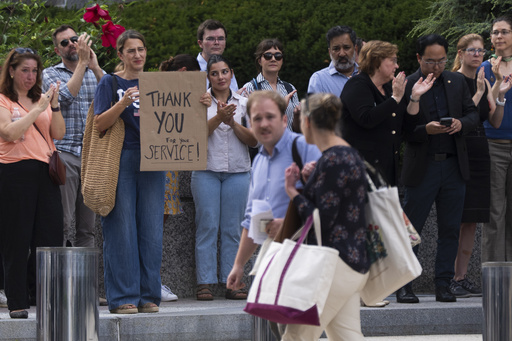 State Department employees applaud as their colleagues walk outside of the State Department headquarters in the Harry S Truman Building, Friday, July 11, 2025, in Washington. (AP Photo/Manuel Balce Ceneta)