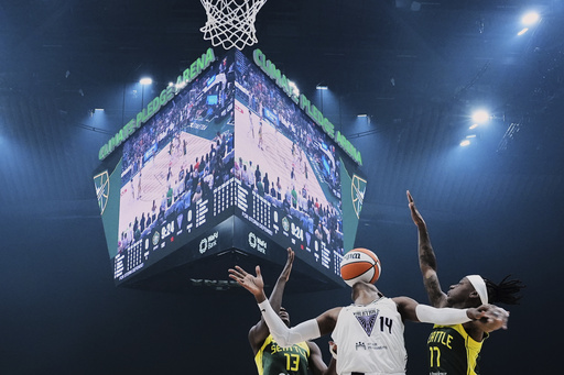 Golden State Valkyries center Temi Fagbenle (14) loses the ball against Seattle Storm forward Ezi Magbegor (13) and guard Erica Wheeler, right, during the first half of a WNBA basketball game Wednesday, July 16, 2025, in Seattle. (AP Photo/Lindsey Wasson)