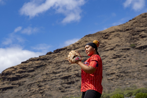 Ry-n Uyeda warms up during a softball practice, Friday, July 11, 2025, in Waianae, Hawaii. (AP Photo/Mengshin Lin)