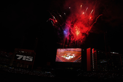 Fans, watch a Hank Aaron Memorial during the MLB baseball All-Star game between the American League and National League, Tuesday, July 15, 2025, in Atlanta. (AP Photo/Brynn Anderson)