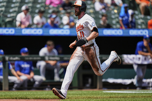 Baltimore Orioles' Jordan Westburg (11) advances toward home plate to score on a sacrifice fly hit by Tyler O'Neill during the first inning in the first baseball game of a doubleheader against the Toronto Blue Jays, Tuesday, July 29, 2025, in Baltimore. (AP Photo/Stephanie Scarbrough)