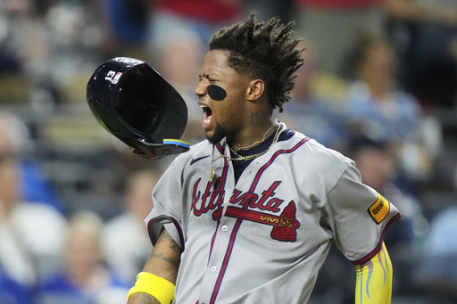 Atlanta Braves' Ronald Acuna Jr. celebrates after scoring on a three-run double hit by Austin Riley during the eighth inning of a baseball game against the Kansas City Royals, Monday, July 28, 2025, in Kansas City, Mo. (AP Photo/Charlie Riedel)