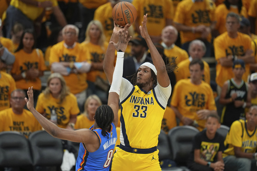 FILE - Indiana Pacers center Myles Turner (33) shoots over Oklahoma City Thunder forward Jalen Williams (8) during the second half of Game 6 of the NBA Finals basketball series, June 19, 2025, in Indianapolis. (AP Photo/Michael Conroy, File)
