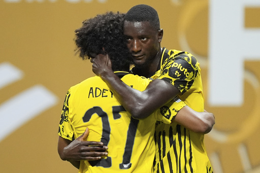 Borussia Dortmund's Serhou Guirassy, right, celebrates with teammate Karim Adeyemi after scoring his team's second goal during the Club World Cup round of 16 soccer match between Borussia Dortmund and CF Monterrey in Atlanta, Tuesday, July 1, 2025. (AP Photo/Mike Stewart)