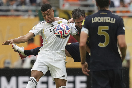 Real Madrid's Kylian Mbappe, left, and Juventus' Daniele Rugani challenge for the ball during the Club World Cup round of 16 soccer match between Real Madrid and Juventus in Miami Gardens, Fla., Tuesday, July 1, 2025. (AP Photo/Lynne Sladky)