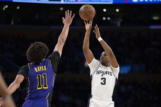 FILE - San Antonio Spurs guard Chris Paul (3) shoots over Los Angeles Lakers center Jaxson Hayes (11) during the first half of an NBA basketball game in Los Angeles, March 17, 2025. (AP Photo/Kyusung Gong, file)