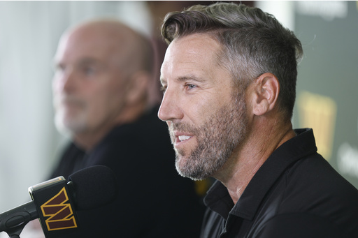 Washington Commanders general manager Adam Peters, right, speaks as head coach Dan Quinn, left, looks on during a news conference at the NFL football team's training camp in Ashburn, Va., Tuesday, July 22, 2025. (AP Photo/Luis M. Alvarez)