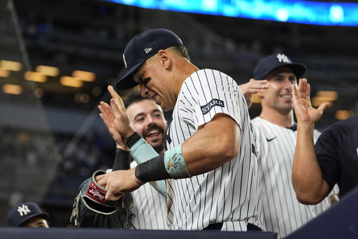 New York Yankees players celebrate with outfielder Aaron Judge, center, after the seventh inning of a baseball game against the Chicago Cubs, Friday, July 11, 2025, in New York. (AP Photo/Yuki Iwamura)