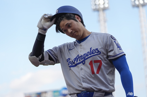 Los Angeles Dodgers' Shohei Ohtani walks to the dugout after striking out during the first inning of a baseball game against the Cincinnati Reds, Tuesday, July 29, 2025, in Cincinnati. (AP Photo/Carolyn Kaster)