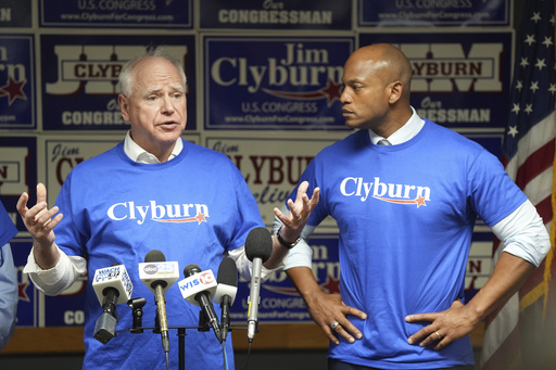 FILE - Minnesota Gov. Tim Walz, left, speaks to reporters as Maryland Gov. Wes Moore looks on at Rep. Jim Clyburn's World Famous Fish, Friday, May 30, 2025, in Columbia, S.C. (AP Photo/Meg Kinnard, File)