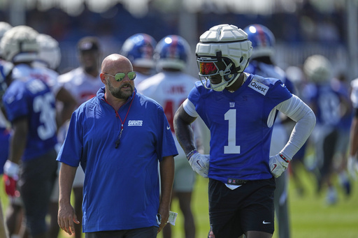 New York Giants wide receiver Malik Nabers, right, talks with head coach Brian Daboll during a practice at the team's NFL football training camp in East Rutherford, N.J., Thursday, July 24, 2025. (AP Photo/Seth Wenig)