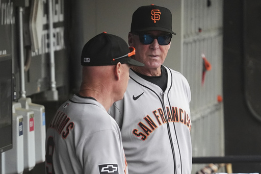 San Francisco Giants manager Bob Melvin, right, talks with third base coach Matt Williams, left, before a baseball game against the Chicago White Sox in Chicago, Sunday, June 29, 2025. (AP Photo/Nam Y. Huh)