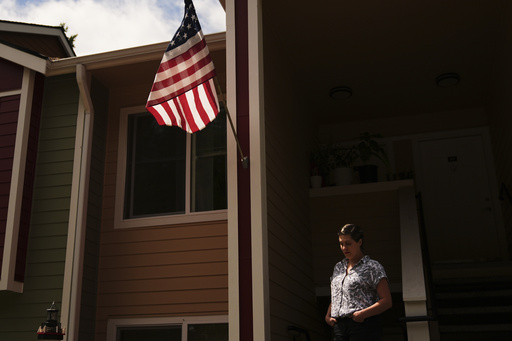 Havalah Hopkins, a single mother who lives in government-subsidized housing with her teenage son, poses for a portrait outside her apartment Thursday, July 10, 2025, in Woodinville, Wash. (AP Photo/Lindsey Wasson)