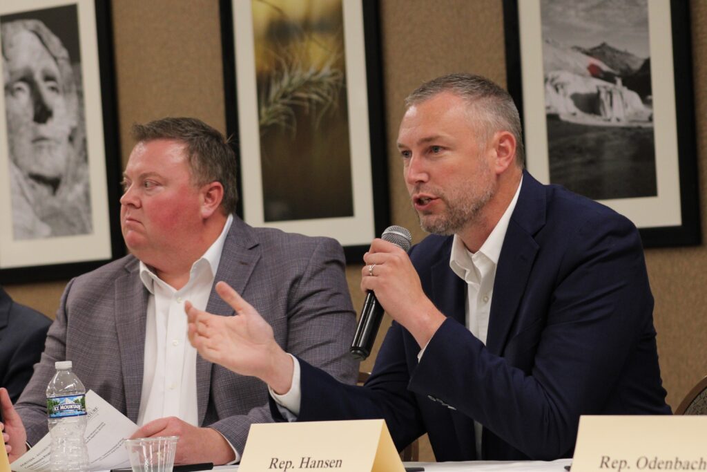 State House Speaker Jon Hansen, R-Dell Rapids, speaks during a Comprehensive Property Tax Task Force meeting on July 16, 2025, at the Ramkota in Rapid City. At left is state Senate President Pro Tempore Chris Karr, R-Sioux Falls. Karr chairs the group, and Hansen is the vice-chair. (Seth Tupper/South Dakota Searchlight)