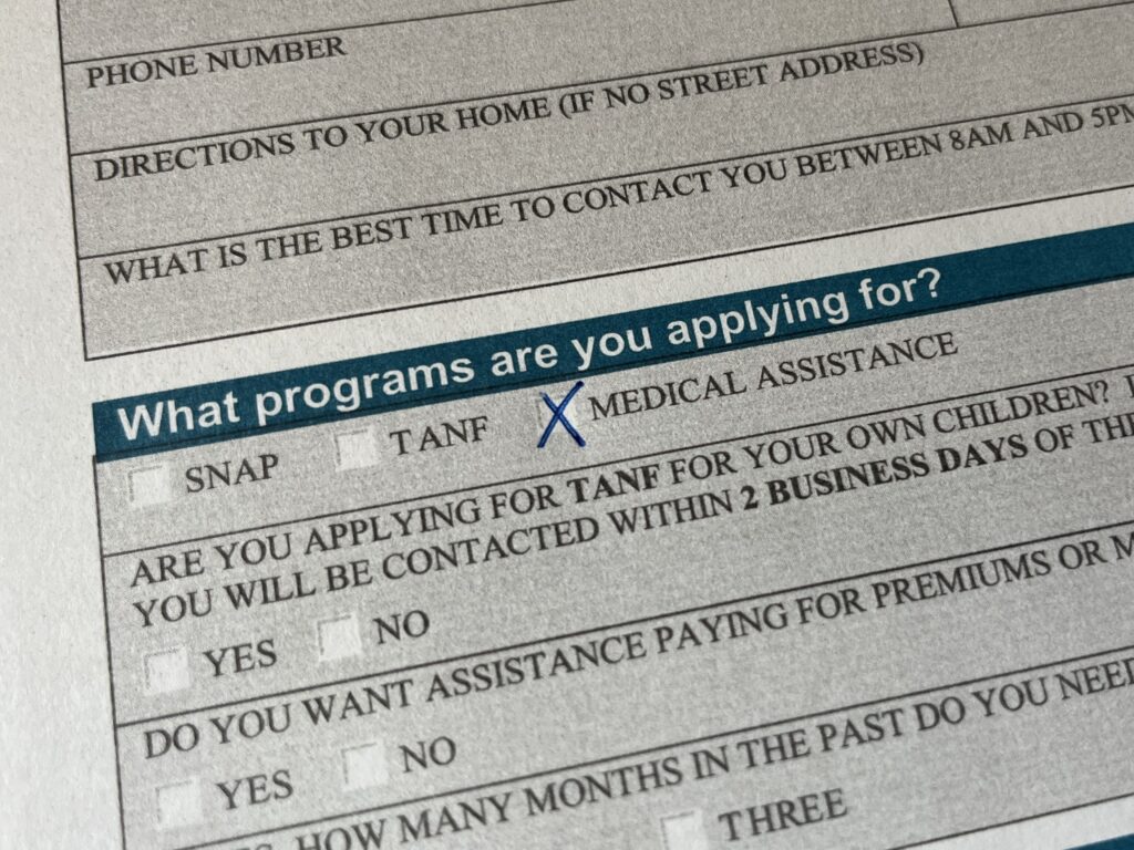 An economic assistance application for the South Dakota Department of Social Services. (Photo illustration by Makenzie Huber/South Dakota Searchlight)