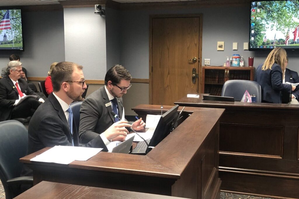 Derek Johnson, state economist with the governor’s Bureau of Finance and Management, and LRC Chief Fiscal Analyst Jeff Mehlhaff (left to right) present to the Revenue Projection Subcommittee in Pierre during the 2023 legislative session. (Makenzie Huber/South Dakota Searchlight)